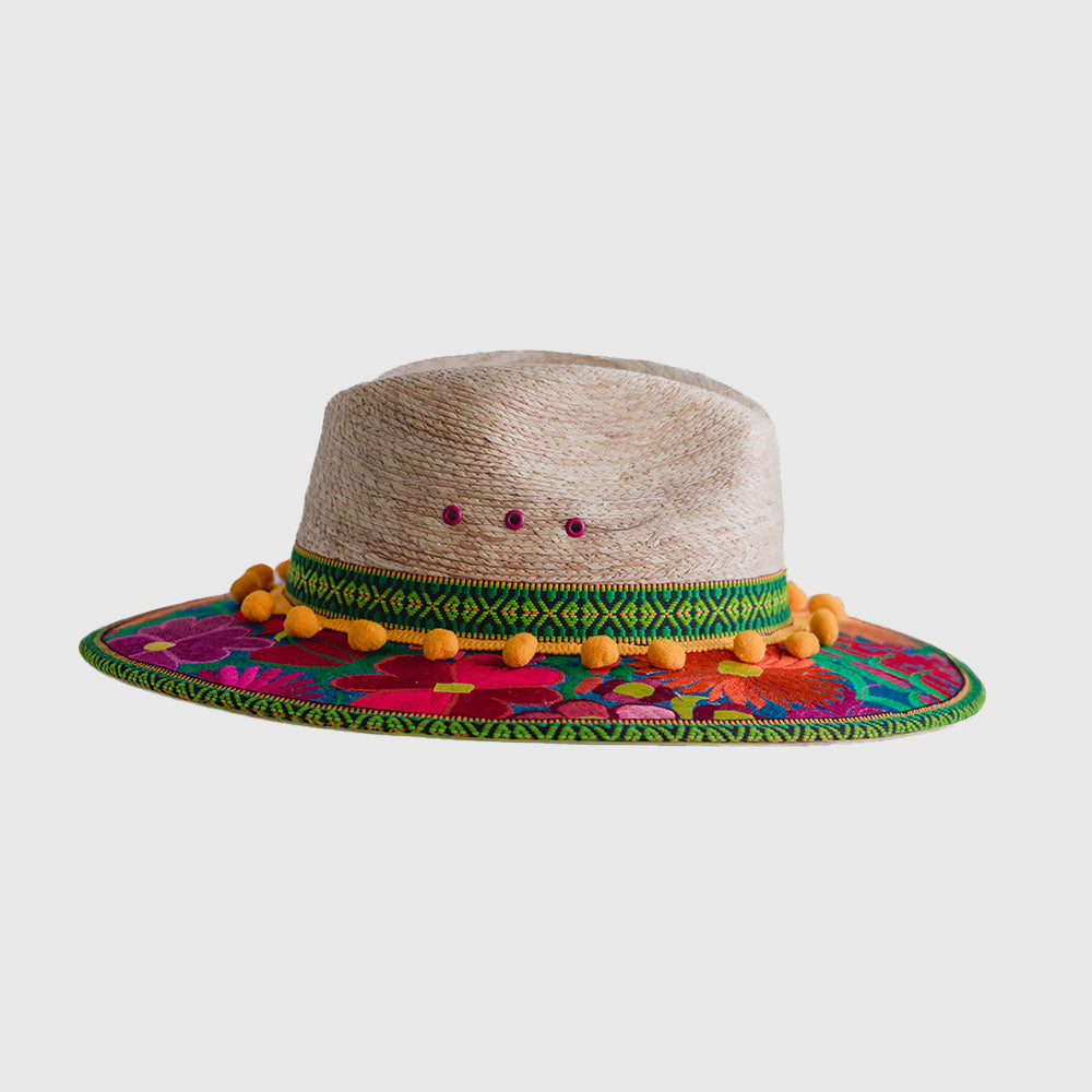 Hat decorated with  yellow, pink and blue embroidered flowers, green ribbon and yellow pompom