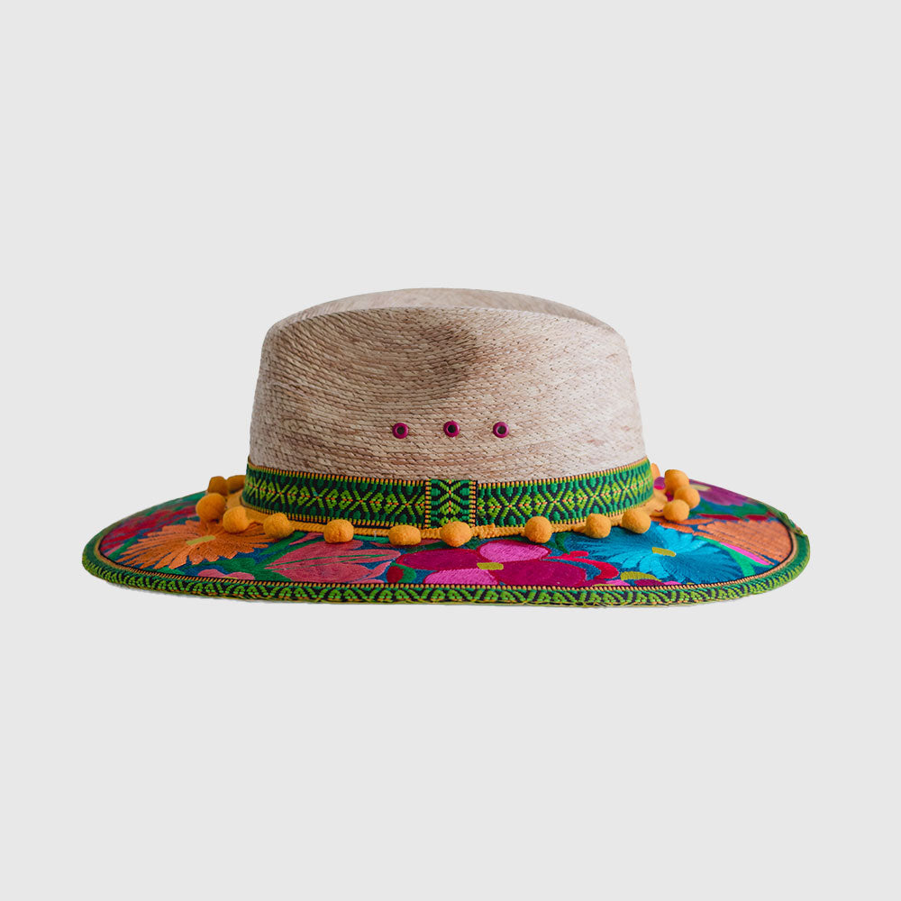 Hat decorated with  yellow, pink and blue embroidered flowers, green ribbon and yellow pompom