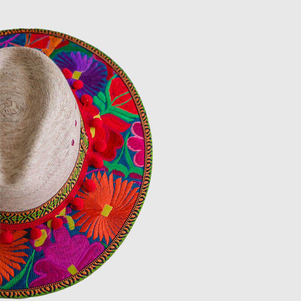 Hat decorated with red embroidered flowers